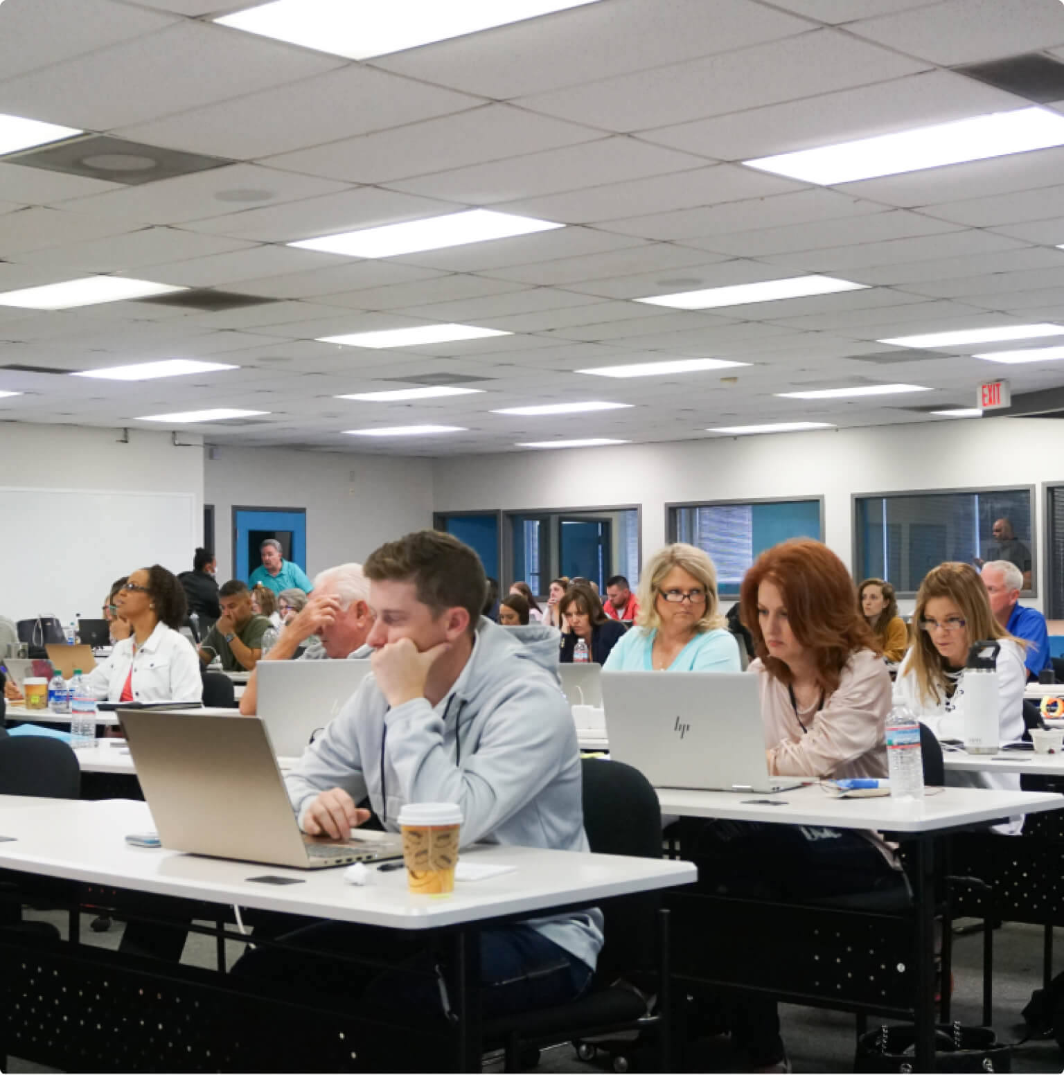 Real estate professionals attending a CINC training class with laptops