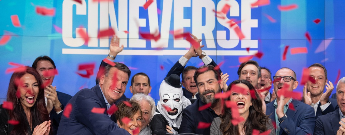 A group celebrates Cineverse amid red confetti, with Art the Clown in the center