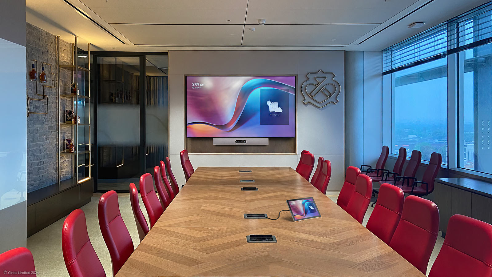 Red chairs and a long table facing a Cisco-equipped screen in Pernod Ricard’s Chivas boardroom