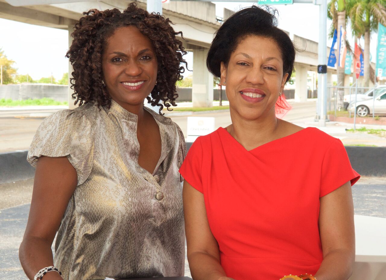 Suzan McDowell standing with OneUnited Bank president Teri Williams
