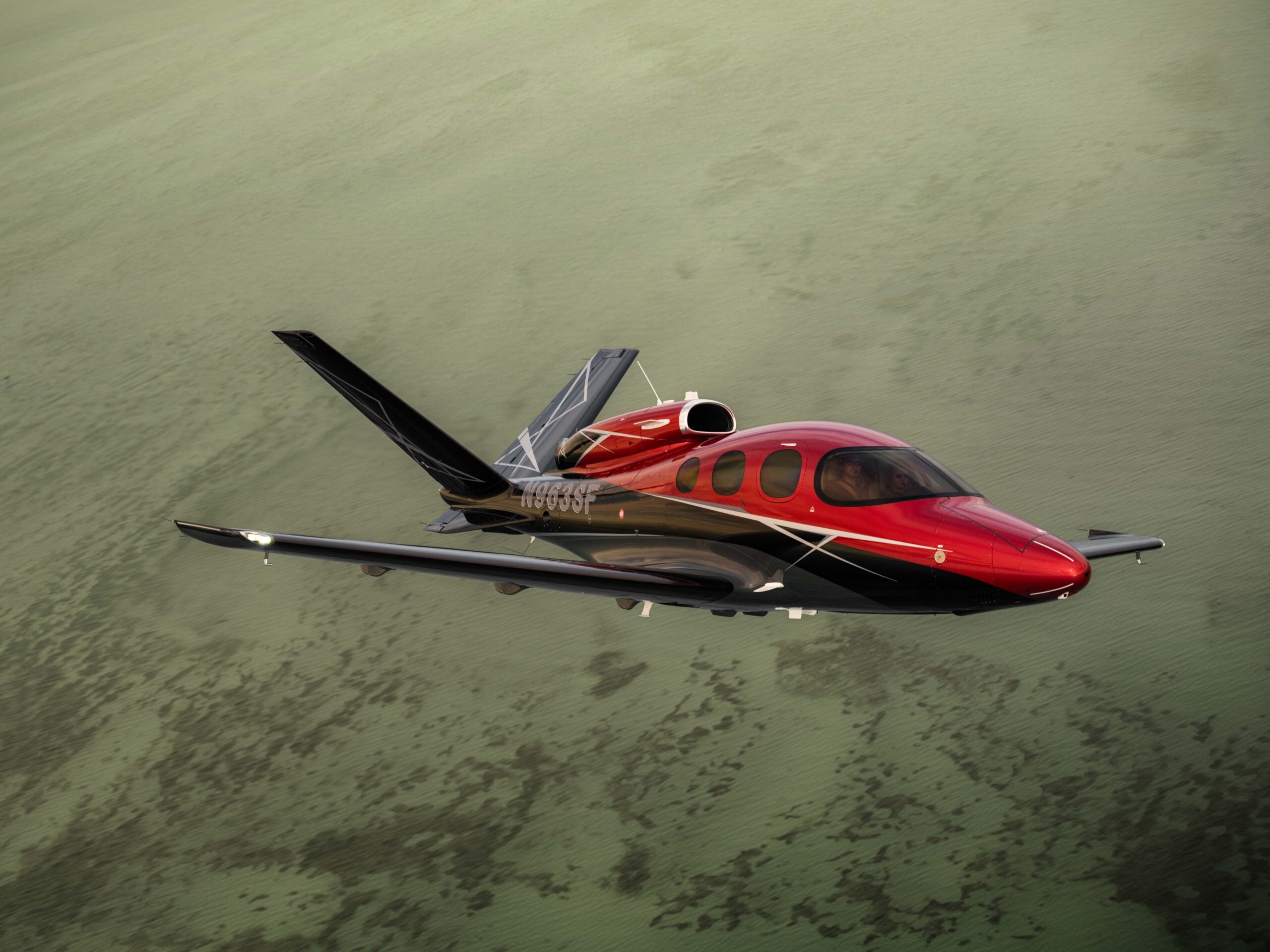 Cirrus G3 Vision Jet flying over water