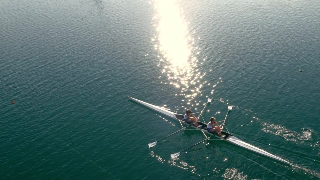 Two rowers moving together across open water