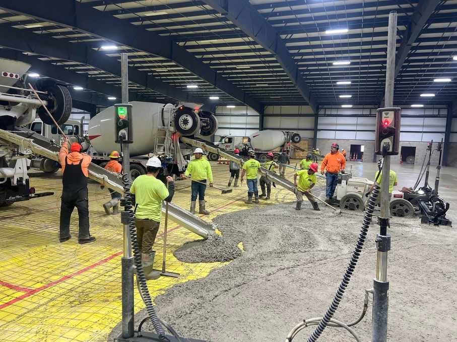 Hermes-Parker Concrete crew working around mixer trucks during a concrete pour at the Lorain County fairgrounds