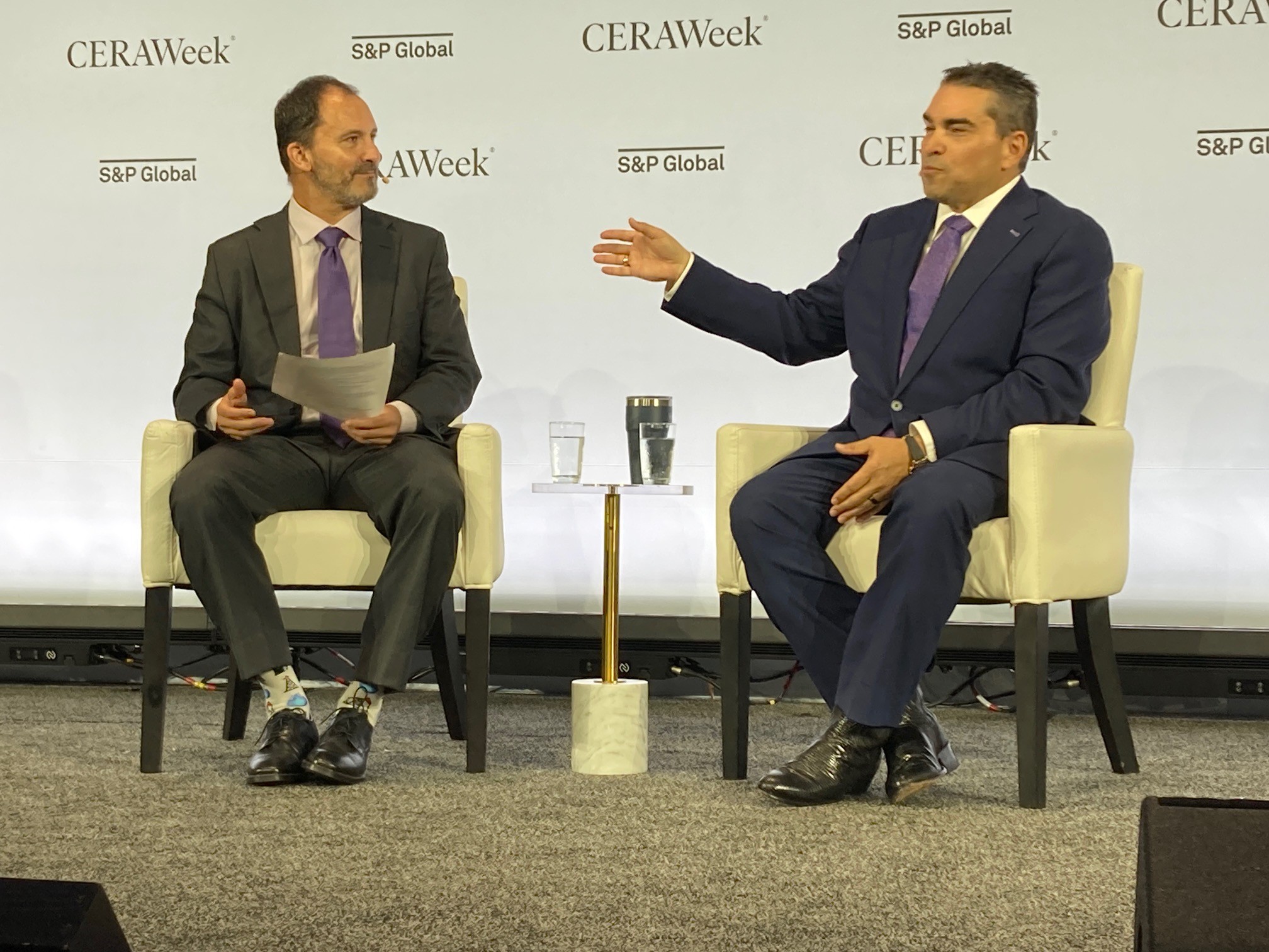 Clay Gaspar, right, gestures while speaking with Raoul LeBlanc at CERAWeek 2026