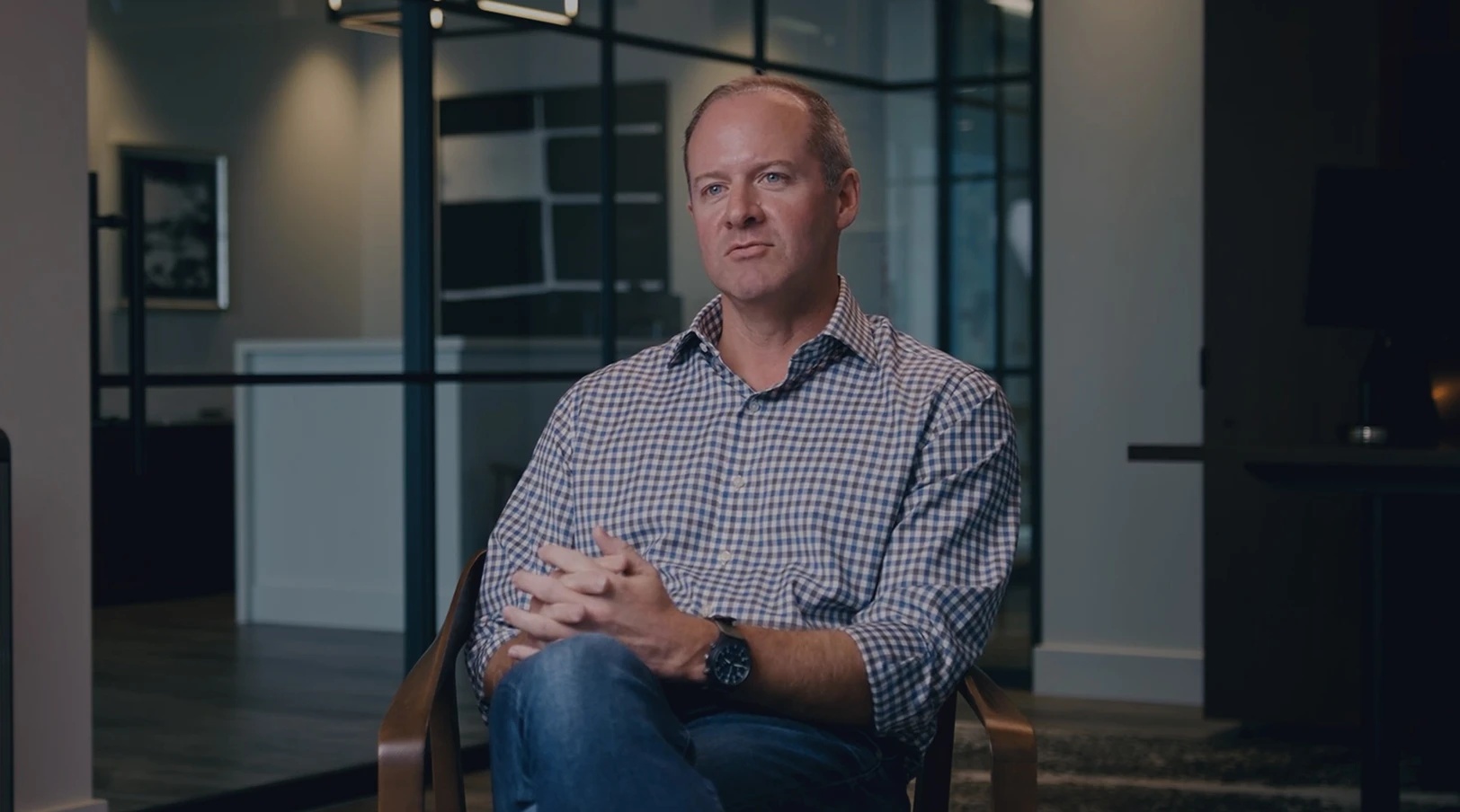 Clay Hunter seated in a Broadview office during a filmed interview about lessons from acquisitions