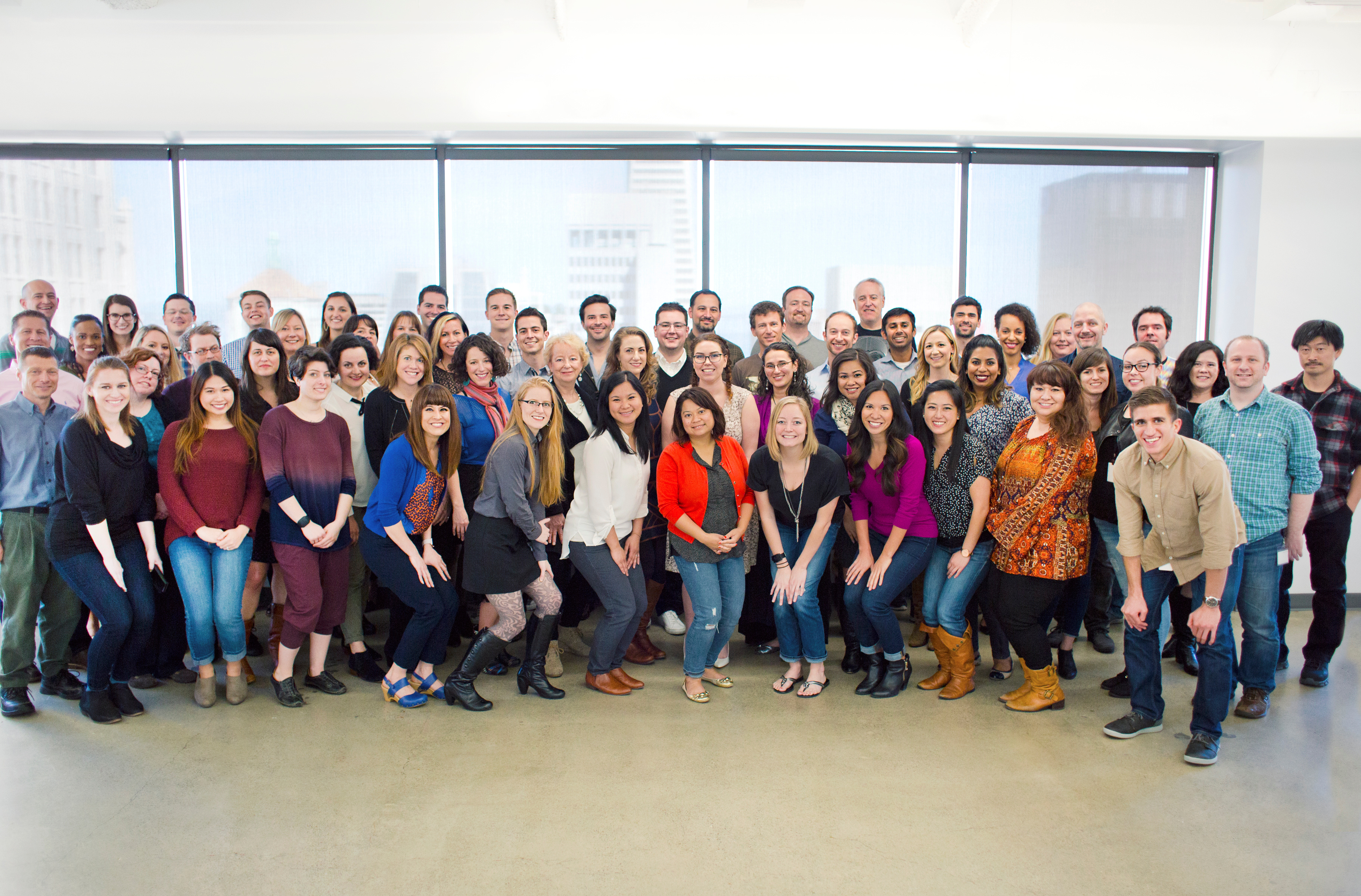 PresenceLearning staff gathered for a team photograph in a bright office