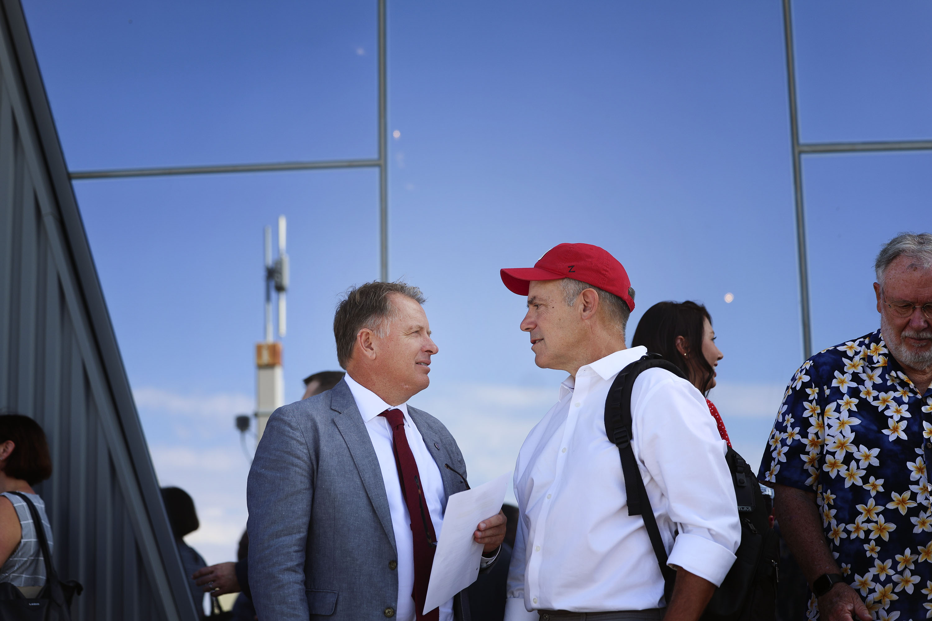 University of Utah president Taylor Randall speaks with Clay Wilkes, wearing a red cap, outside the Natural History Museum of Utah.