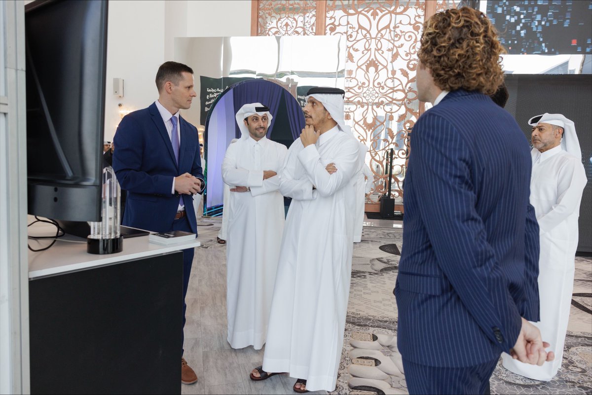 Clemens Mewald, at left in a navy suit, discussing the building permit system with Qatari officials