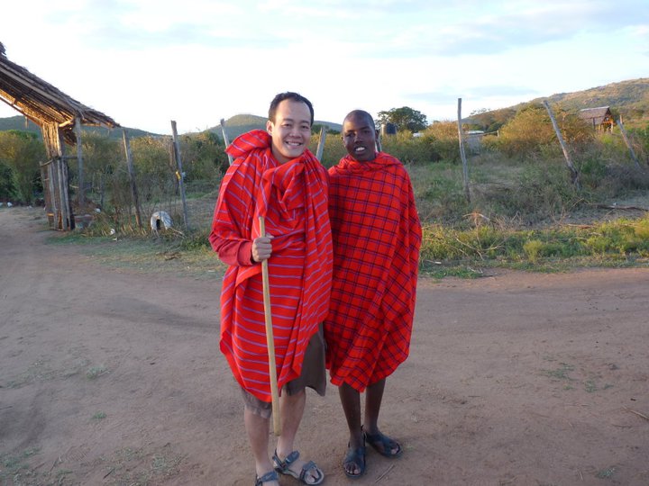 Clement Wong standing beside a Maasai man during his visit to Kenya