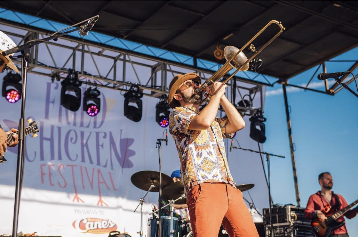 A trombonist performing onstage at the Fried Chicken Festival