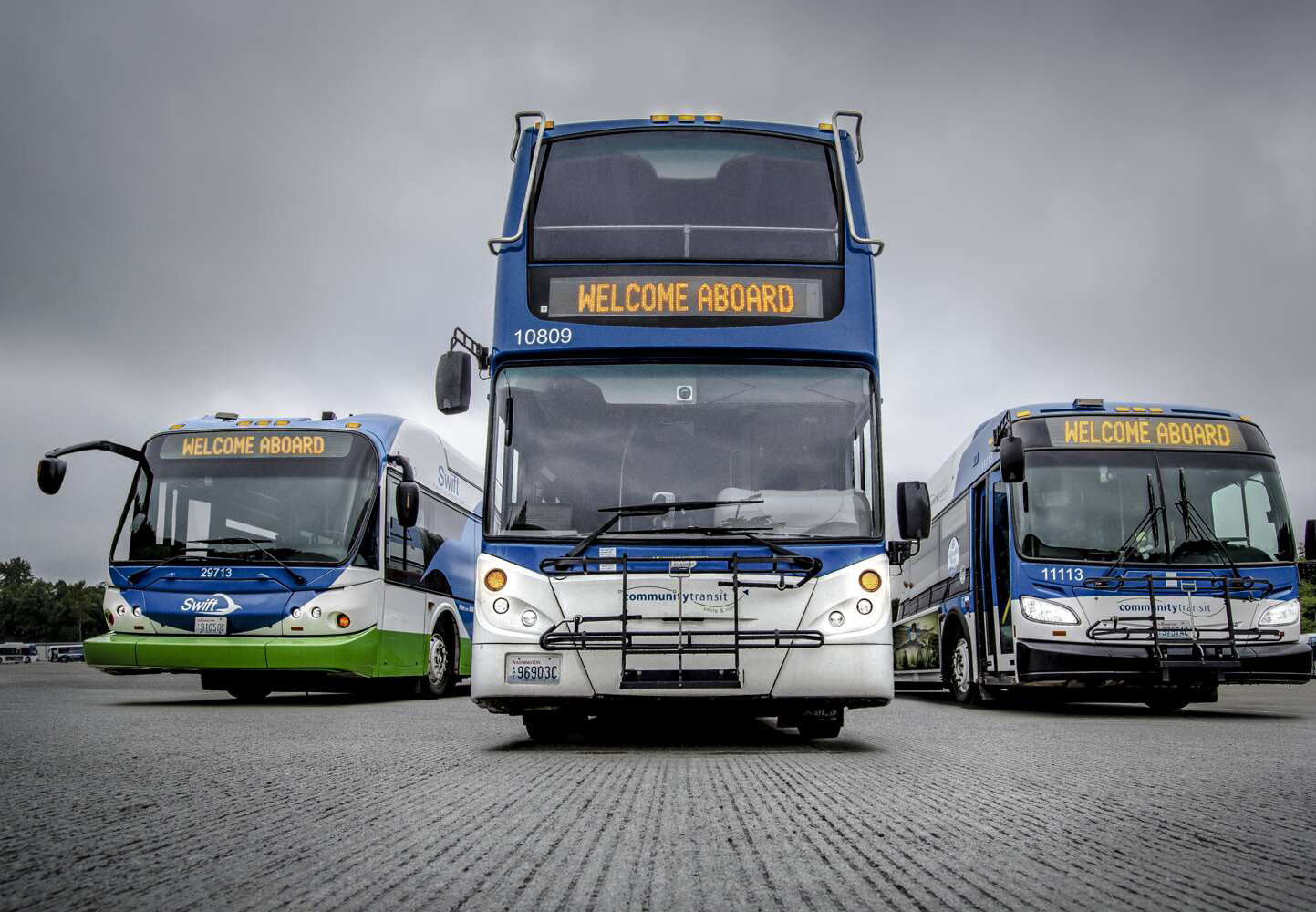 Three Community Transit buses facing the camera, including a double-decker