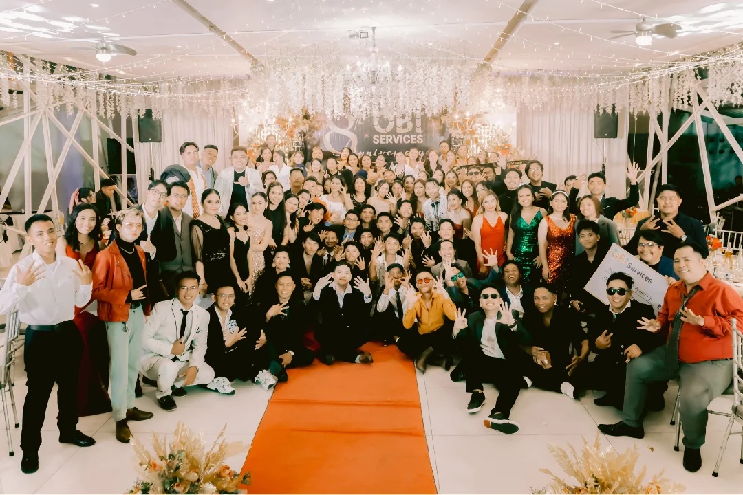 OBI Services employees and guests gathered for a group photograph at the eighth-anniversary gala