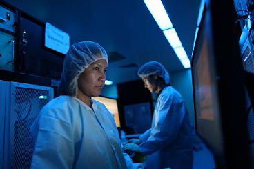 Two technicians working inside a Complete Genomics sequencing facility