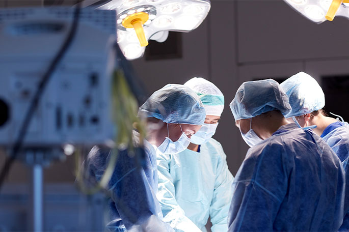 Surgeons and clinicians reviewing a case