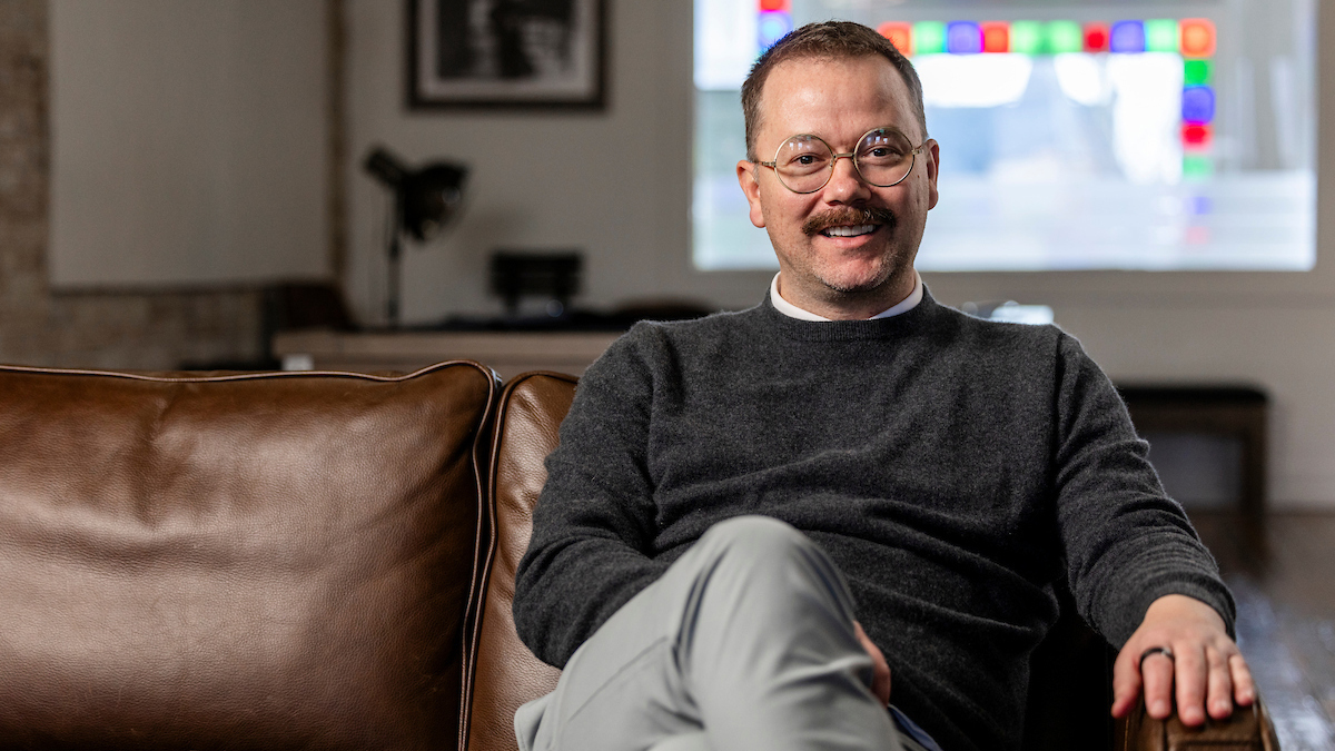 Clint Betts sitting on a brown leather sofa during the UVU profile session