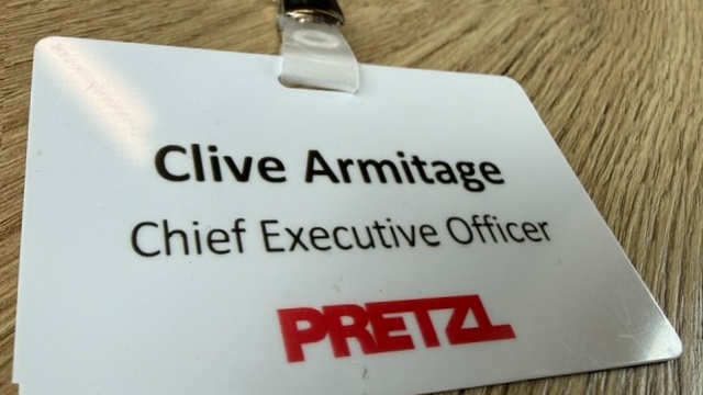 Clive Armitage’s Pretzl Chief Executive Officer name badge on a wooden surface