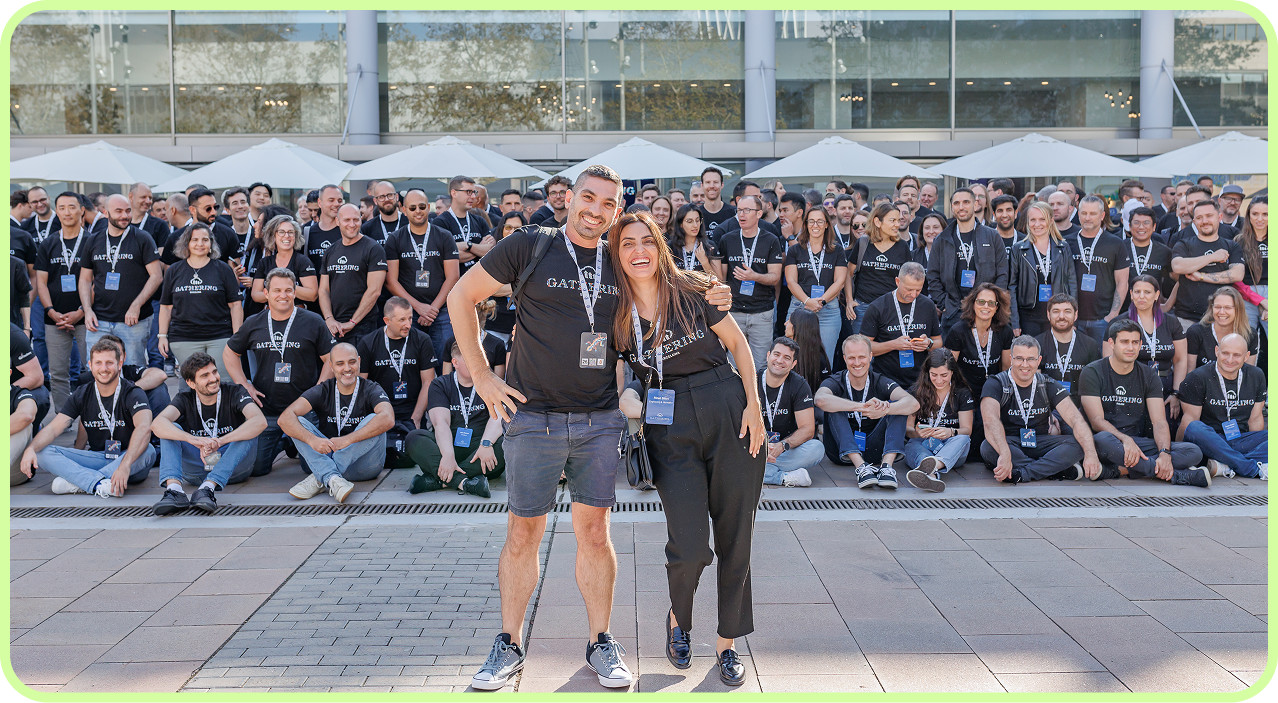 Cloudinary employees gathered outdoors in matching event shirts