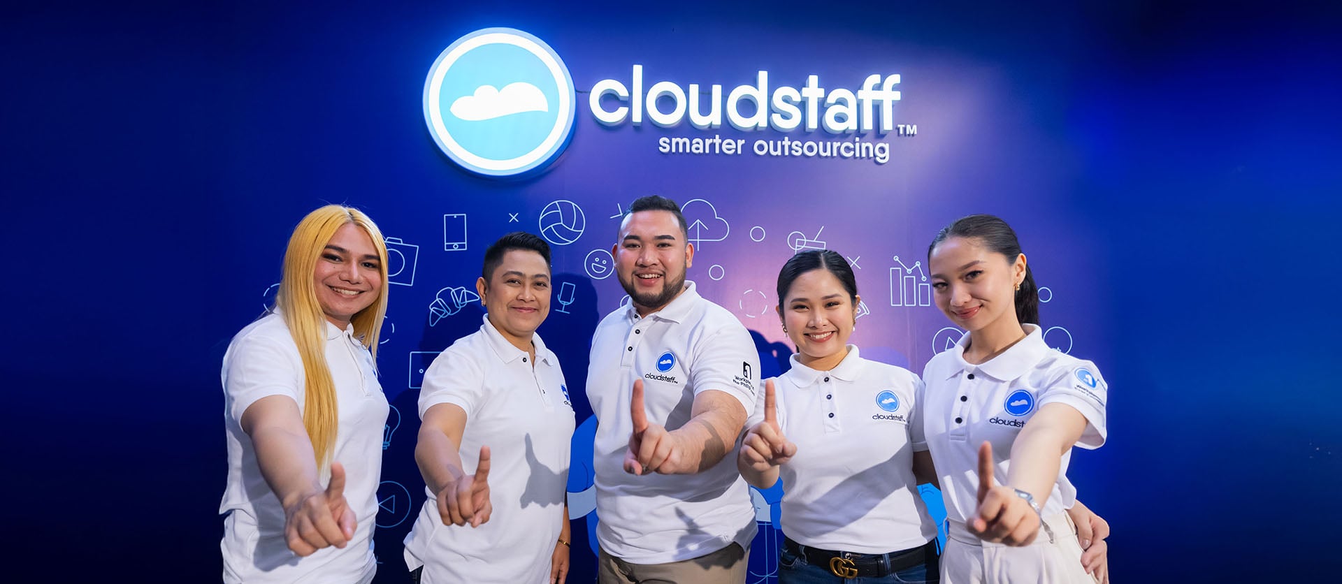 Five Cloudstaff community members posing together in company shirts