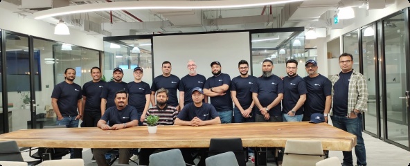 Cloudways team members gathered around an office table