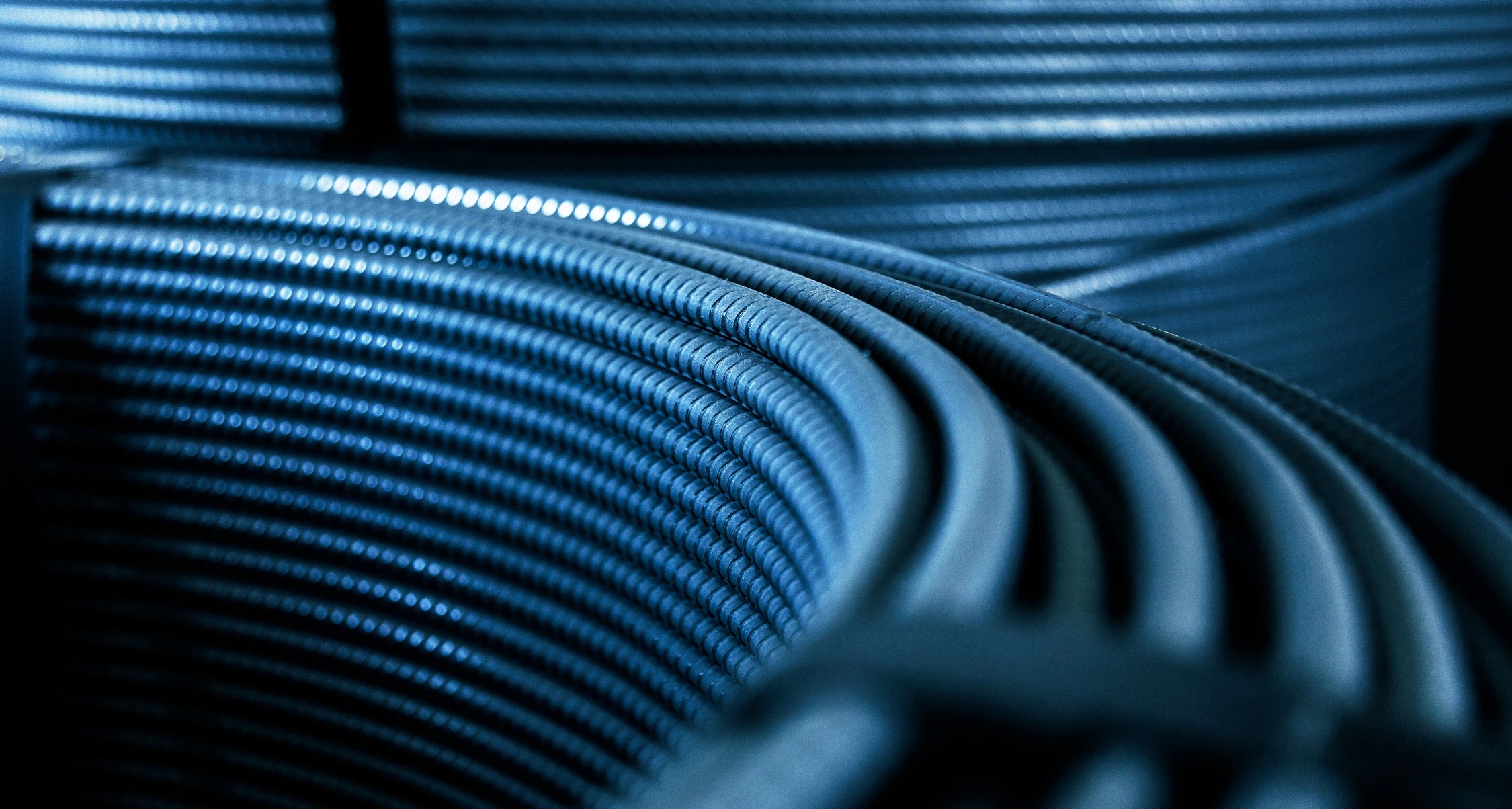 Close view of ribbed reinforcing steel wound into spools