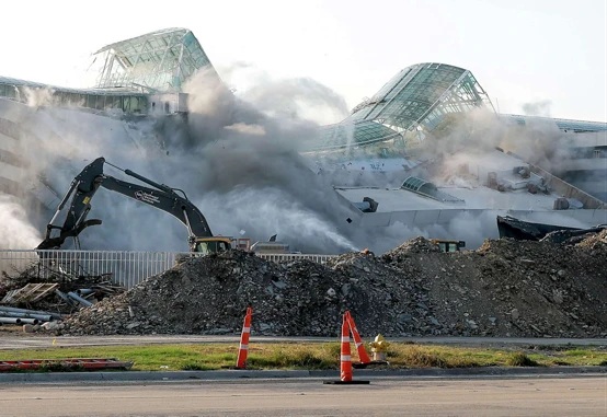 Demolition of the former EDS headquarters, with excavators and recoverable material in the foreground