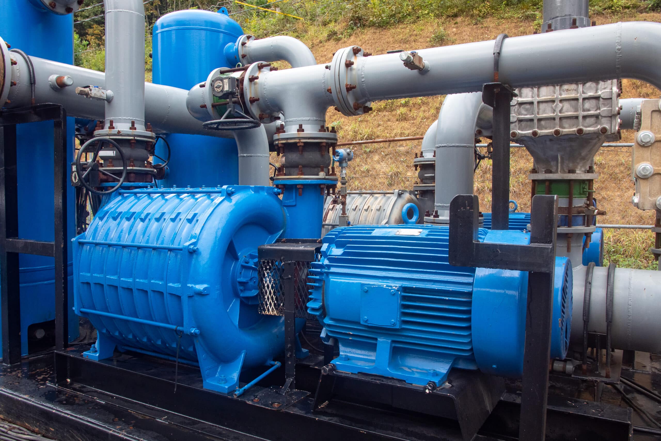 Blue compressors and connected piping at CNX’s Virginia mine-gas operations