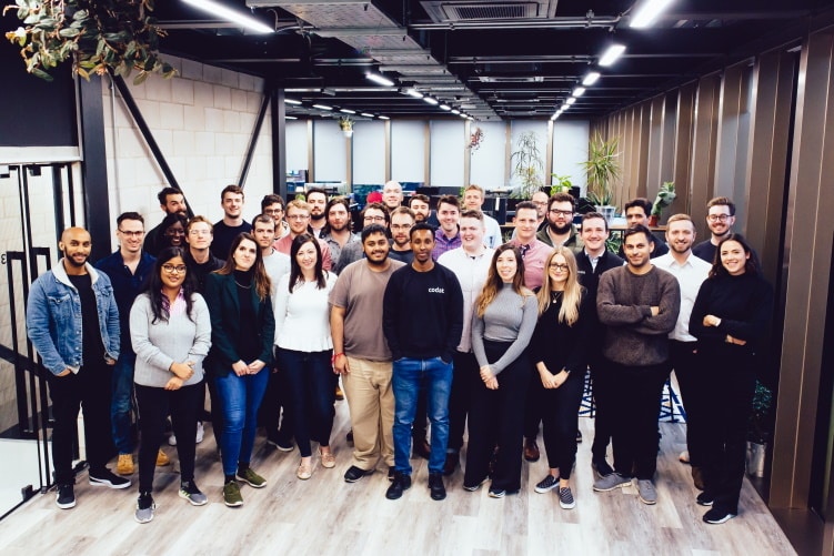 Codat team gathered in an office in an archival company photograph