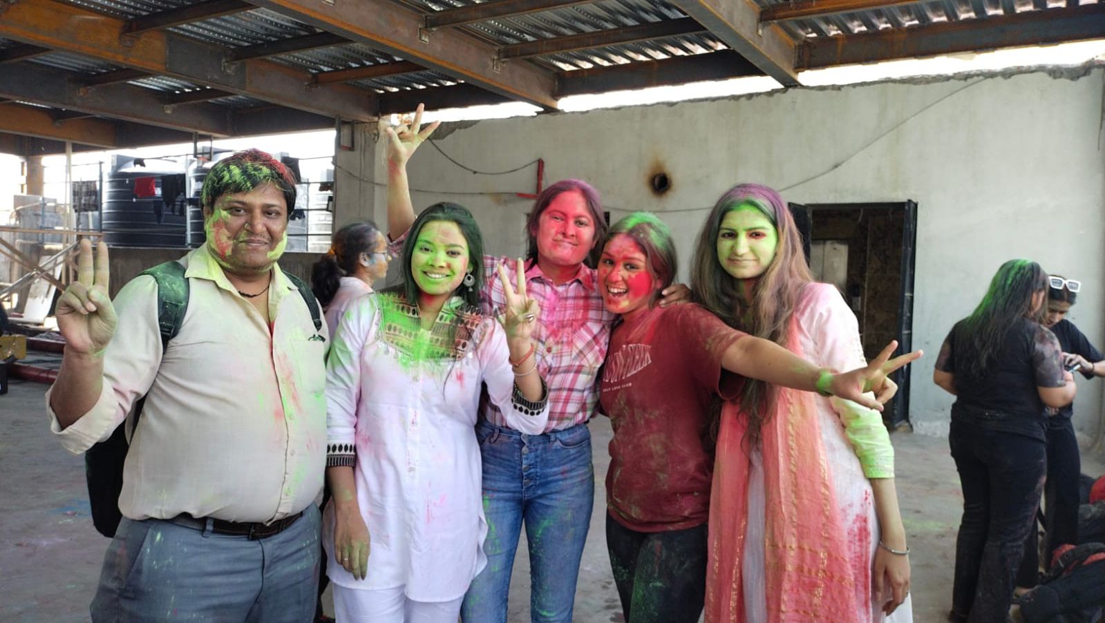 People in CodeVyasa’s published team photograph celebrating with bright colored powder
