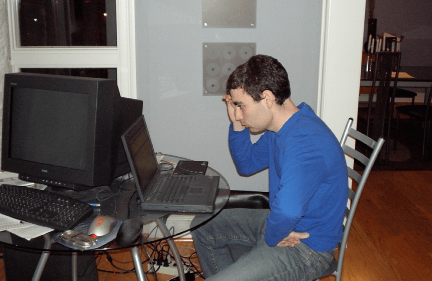 An archival photograph of Jesse Lipson working at a laptop beside a large monitor