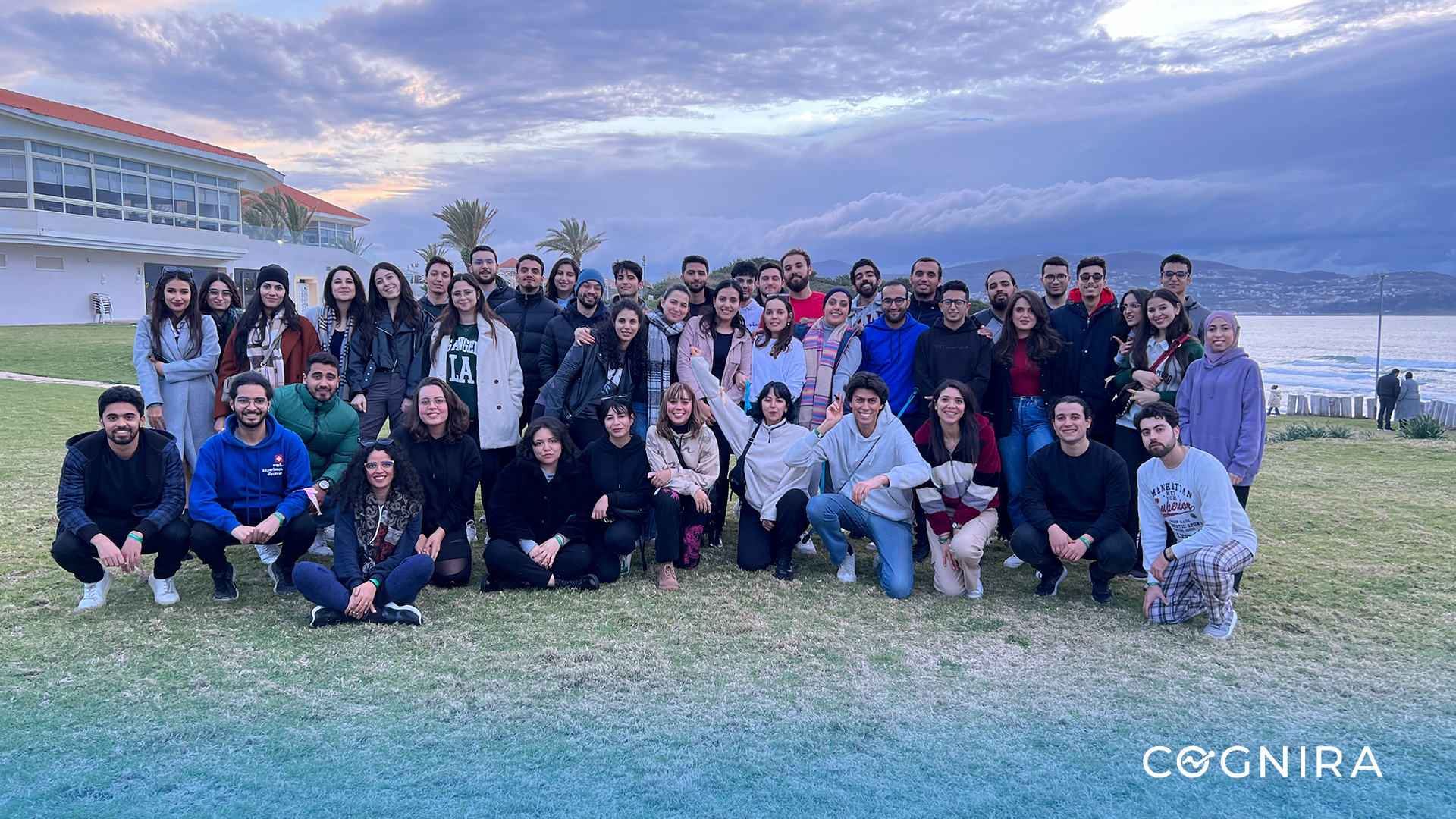 Cognira colleagues gathered outdoors beside the water