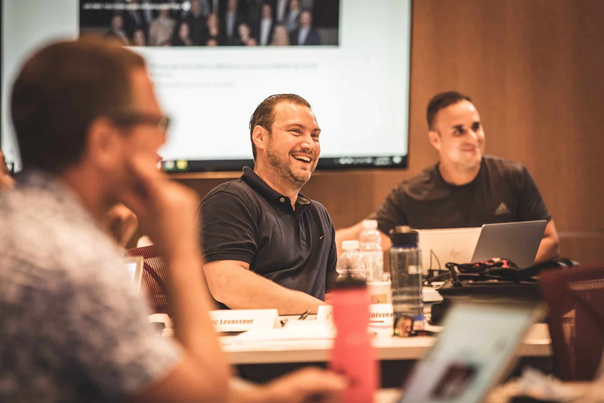 Entrepreneurs seated around a classroom table at EEB