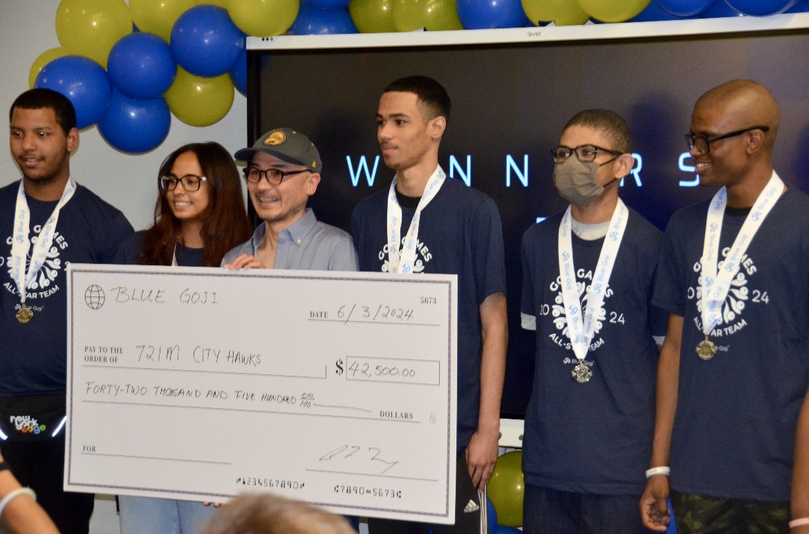 Coleman Fung, in a cap, joins City Hawks competitors holding a $42,500 prize check