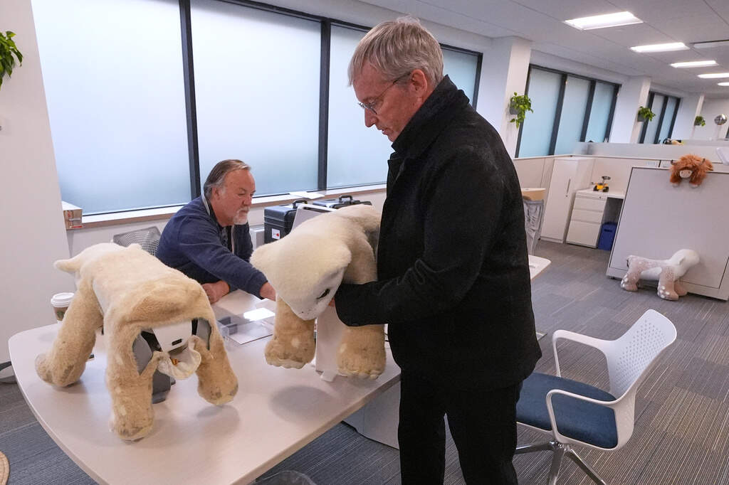 Colin Angle lifting the soft four-legged Familiar prototype during a demonstration