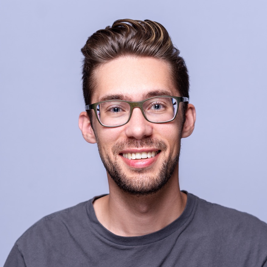 Colin Ardern wearing glasses and a dark gray shirt