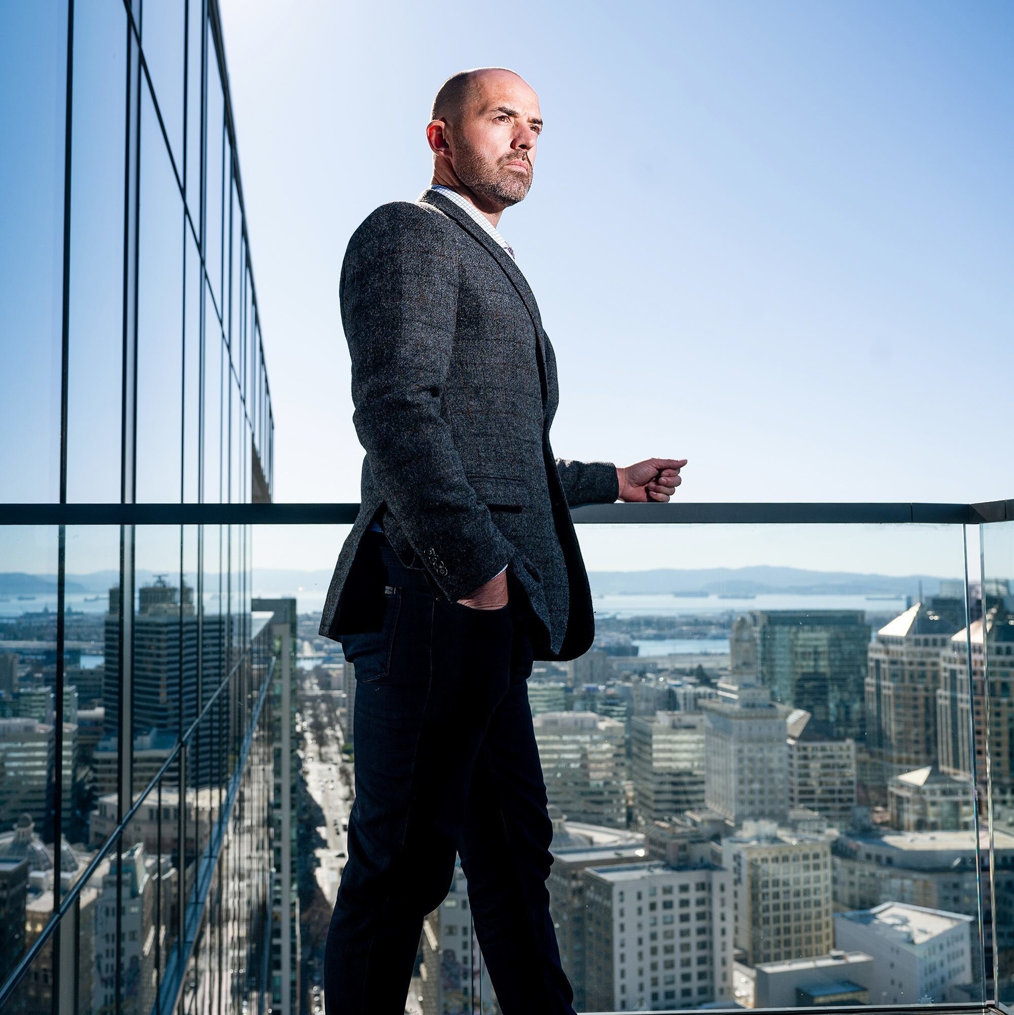 Colin Behring on a balcony overlooking downtown Oakland