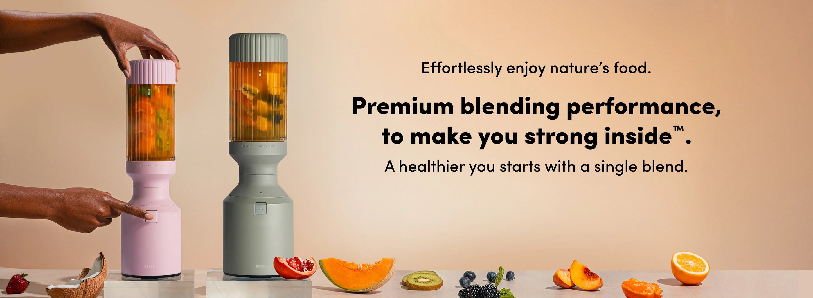 Two ribbed Beast blenders on a counter surrounded by fruit