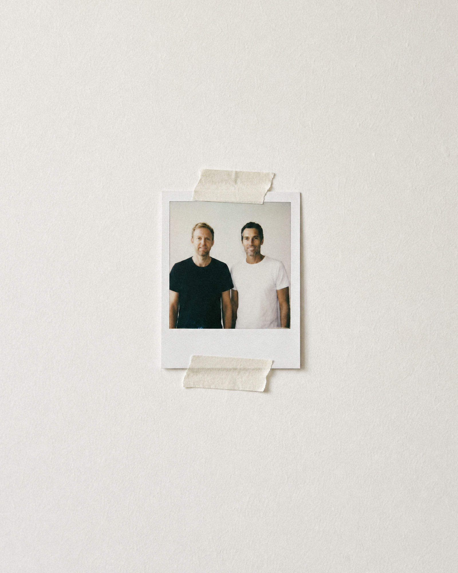 Colony founders Adam Renfree and Adam Nathanson photographed in a small instant print taped to a wall