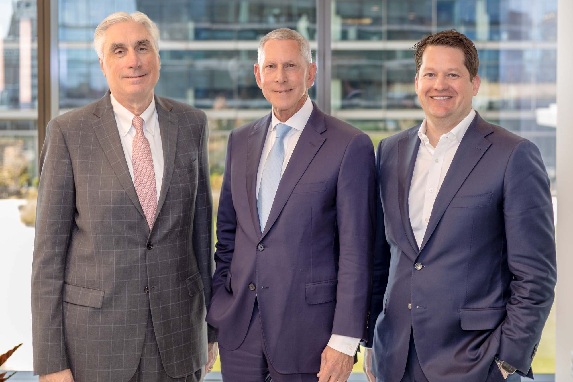 John Handy, Joseph Catti and John Kemper standing together in front of office windows