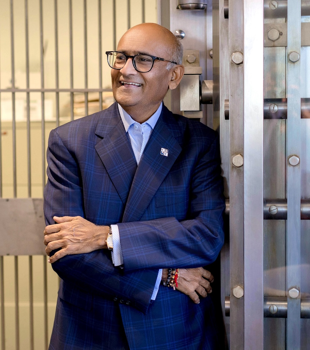 CBC chief executive Ash Patel standing beside the open door of a bank vault