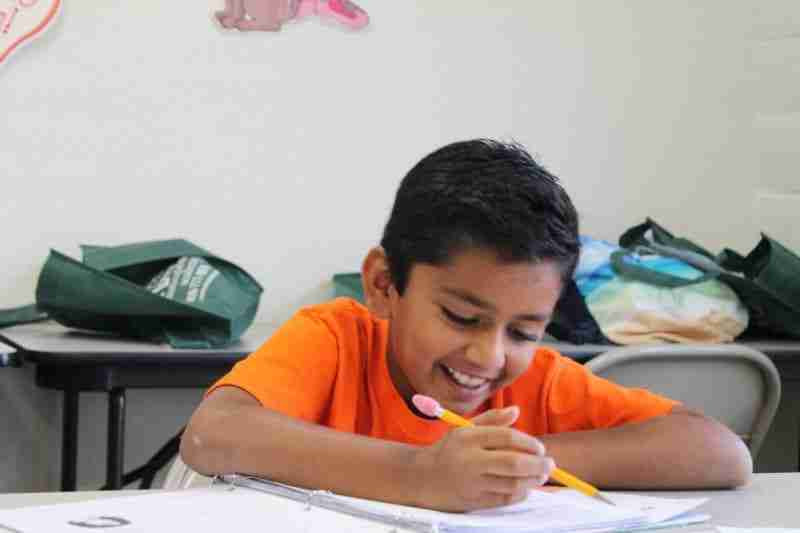 A student working on a writing exercise at Communication Academy