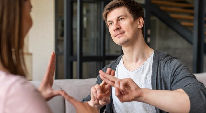 Two people communicating in sign language