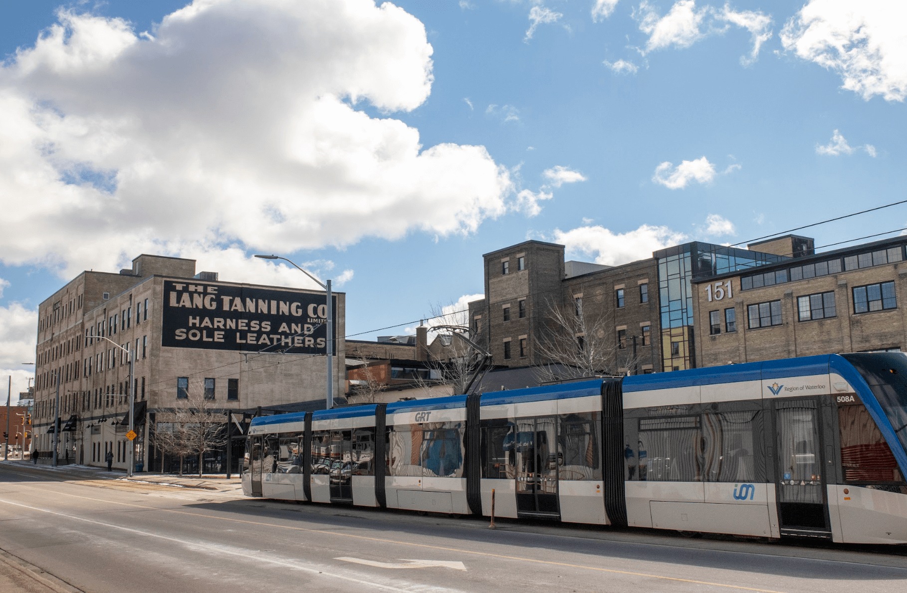 An ION light rail train passes the former Lang Tannery, home of the Communitech Hub in Kitchener.