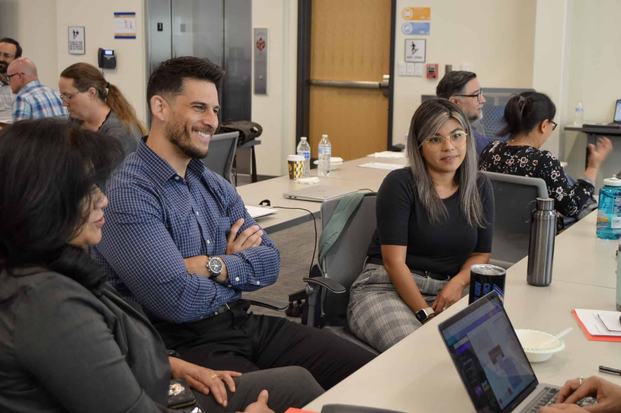 People seated around tables with laptops during a workshop pictured on CCA’s Accelerator website