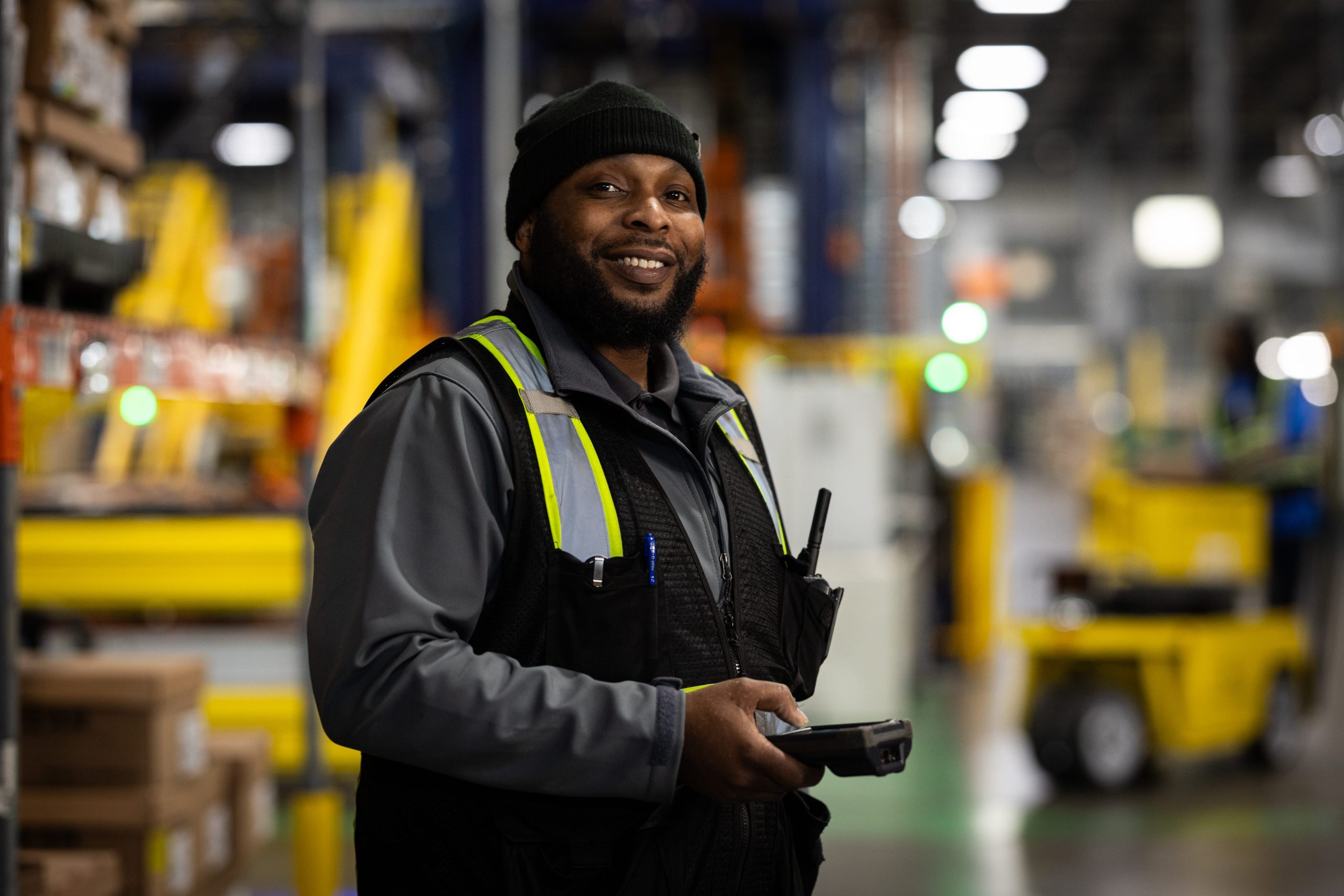 CLI employee using a handheld scanner in a warehouse
