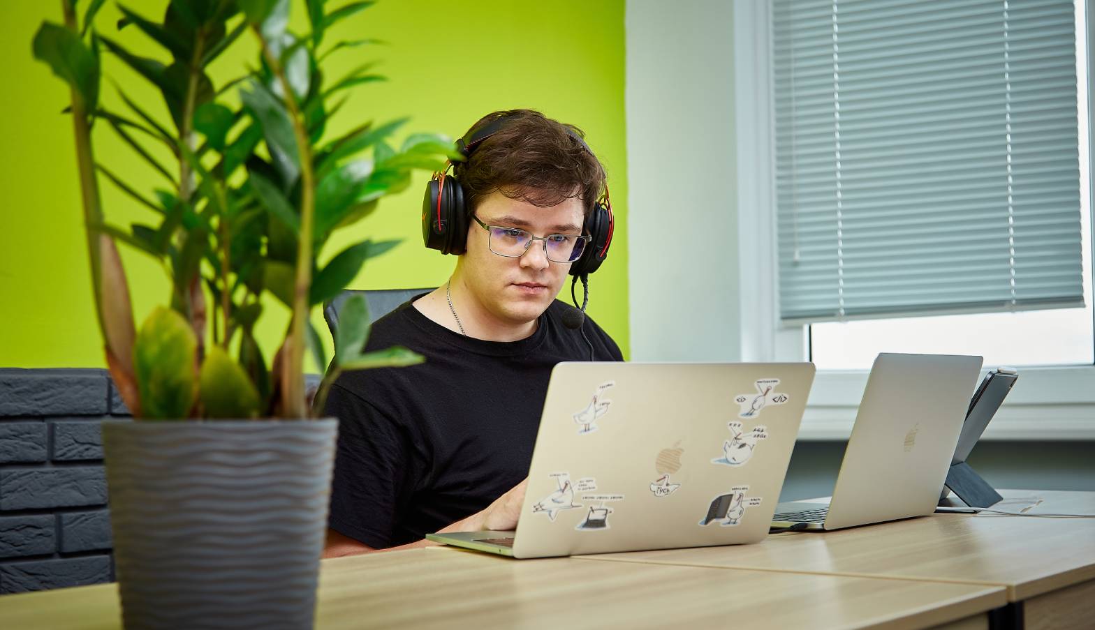 A Computools employee working at laptops in an office