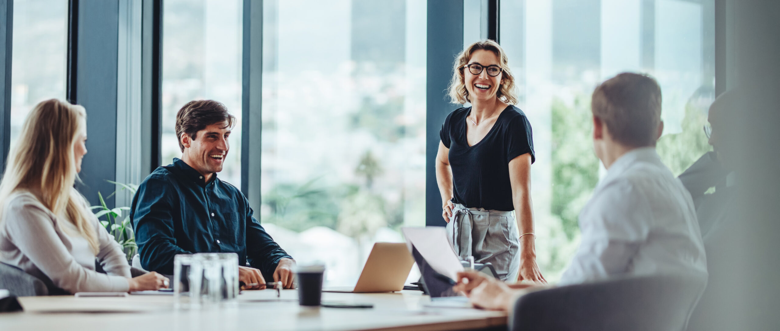 Consultants gathered around a table in a bright meeting room