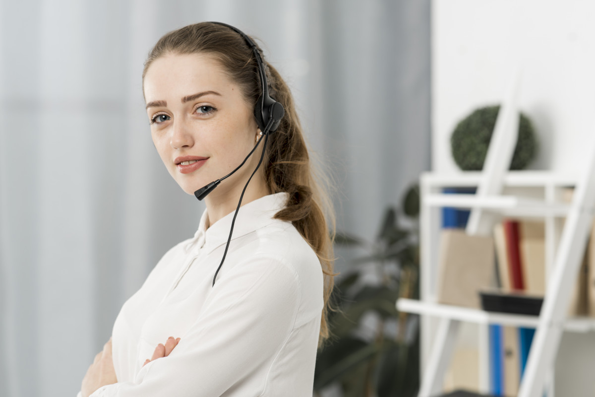 Customer support representative wearing a headset in an office
