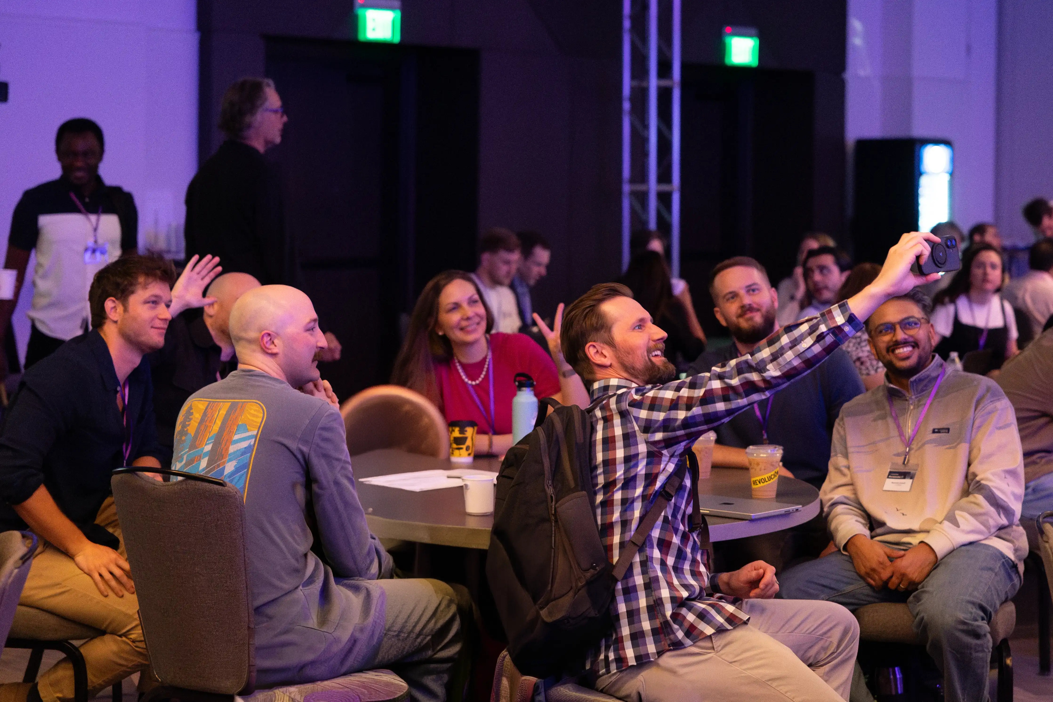 People at a Contentstack company gathering posing together for a phone photograph