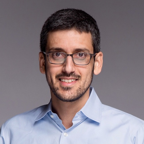 ConvertMedia co-founder Yoav Naveh wearing glasses and a blue shirt