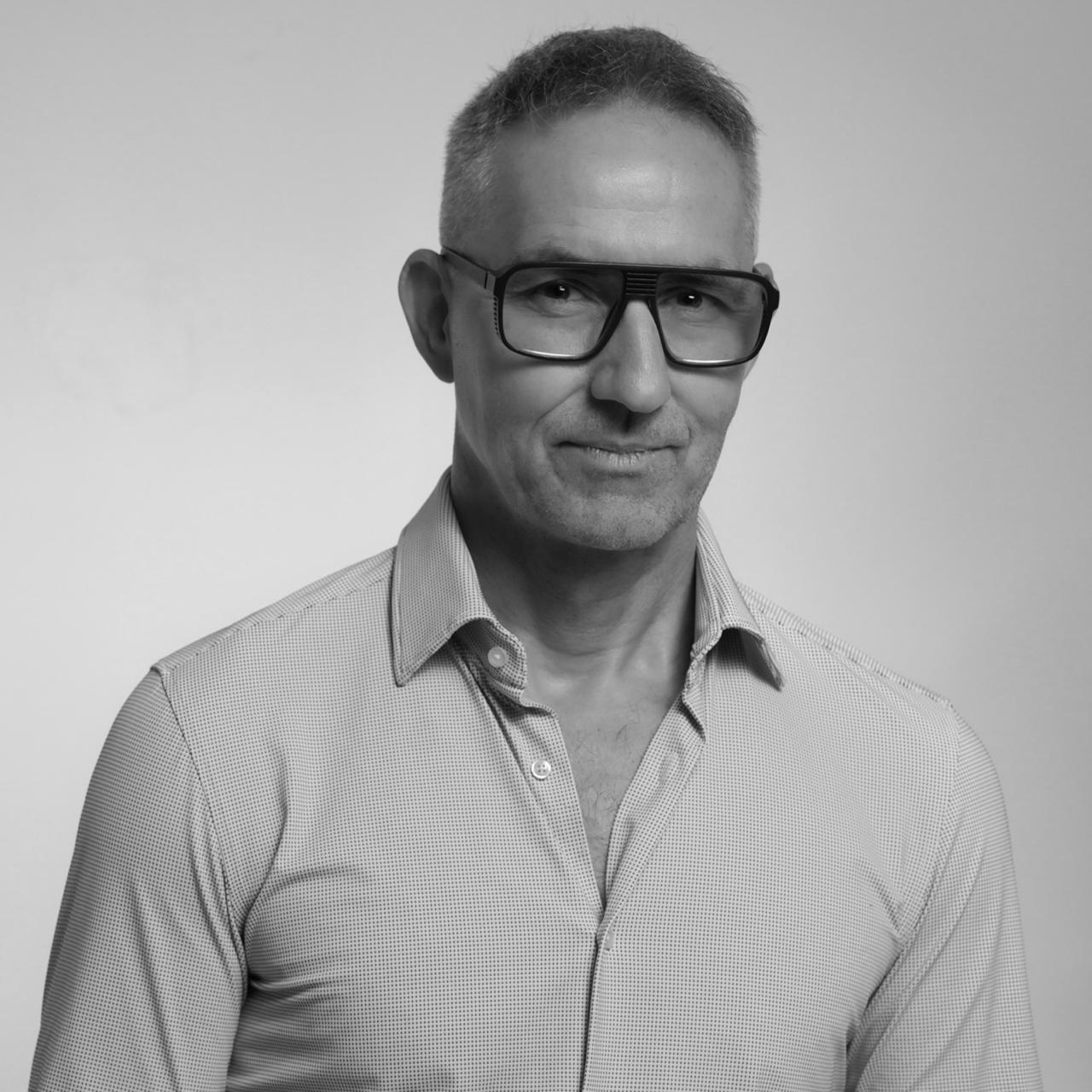 Black-and-white portrait of Branko Lukic wearing dark glasses